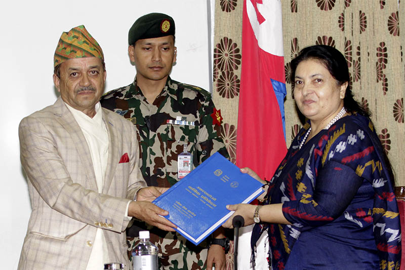 PSC Chairperson Umesh Prasad Mainali (left) submits the annual report to President Bidya Devi Bhandari at Sheetal Niwas, in Kathmandu, on Thursday, October 11, 2018. Photo: RSS