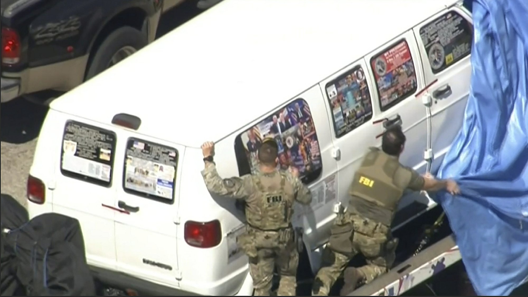 This frame grab from video provided by WPLG-TV shows FBI agents covering a van after the tarp fell off as it was transported from Plantation, Fla., on Friday, Oct. 26, 2018, that federal agents and police officers have been examining in connection with package bombs that were sent to high-profile critics of President Donald Trump. Photo: AP