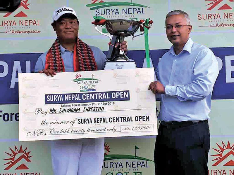 Shivaram Shrestha receives the trophy from Vice-president of Surya Nepal Pvt Ltd Dipra Lahiri (right) after the Surya Nepal Central Open in Kathmandu on Thursday. u00a0Photo Courtesy: NPGA