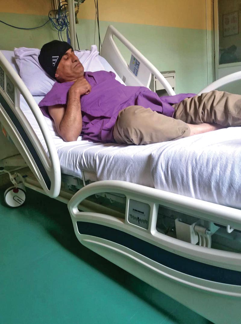 Senior orthopaedic surgeon Dr Govinda KC resting on a hospital bed after undergoing treatment, in Kathmandu, on Monday, November 19, 2018. Photo: THT