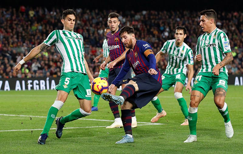 Barcelona's Lionel Messi in action with Real Betis' Marc Bartra  during the La Liga Santander match between FC Barcelona and Real Betis, at Camp Nou, in Barcelona, Spain, on November 11, 2018. Photo: Reuters