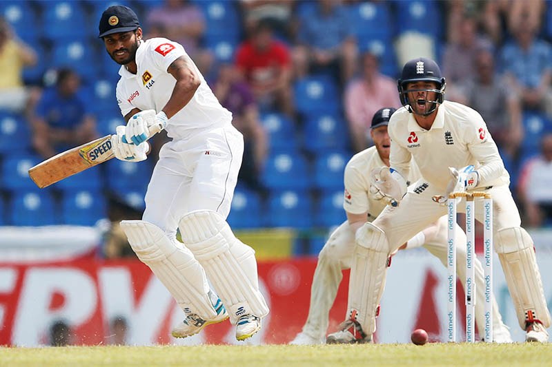 Sri Lanka's Roshen Silva (L) plays a shot next to England's wicketkeeper Ben Foakes. Photo: Reuters