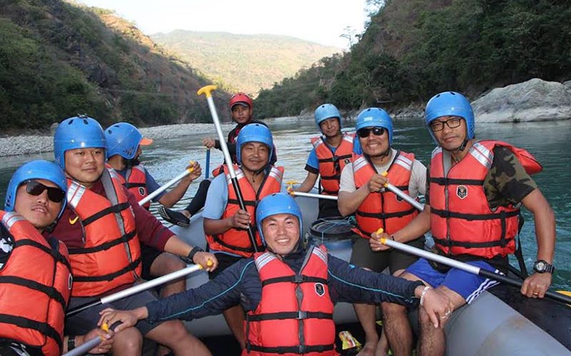 Youths enjoying rafting in the Tamor River in Pinashi, Panchthar, on Wednesday. Photo: THT