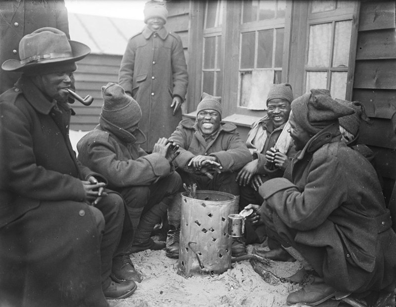 In this undated handout photo provided by the Imperial War Museum on Friday, Nov, 30 2018, African men gather around a fire for warmth during World War I. Amid the fanfare marking the 100th anniversary of the end of World War I, little has been said about some crucial participants in the conflict: Africans. More than 1 million African soldiers, labourers and porters were vital actors in the war in Europe and especially in battles on the African continent, yet little commemorates their role. Photo: Imperial War Museum via AP