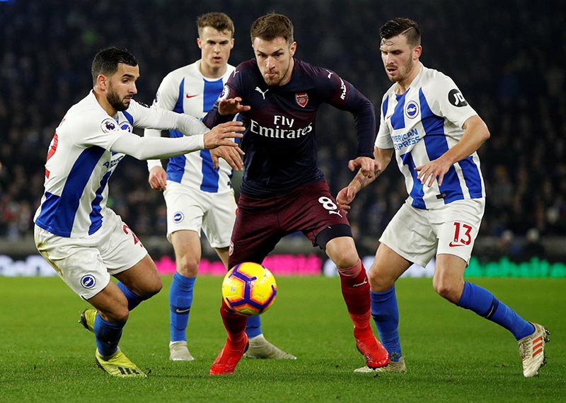 Arsenal's Aaron Ramsey in action with Brighton's Martin Montoya (left) and Pascal Gross (right) during the Premier League match between Brighton &amp; Hove Albion and Arsenal, at The American Express Community Stadium, in Brighton, Britain , on December 26, 2018. Photo: Action Images via Reuters