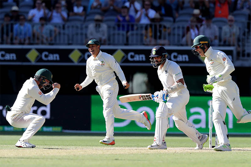 Australia's players celebrate the dismissal of India's Murali Vijay after being bowled by Nathan Lyon of Australia on day four of the second test match between Australia and India at Perth Stadium in Perth, Australia, December 17, 2018. Photo: Reuters
