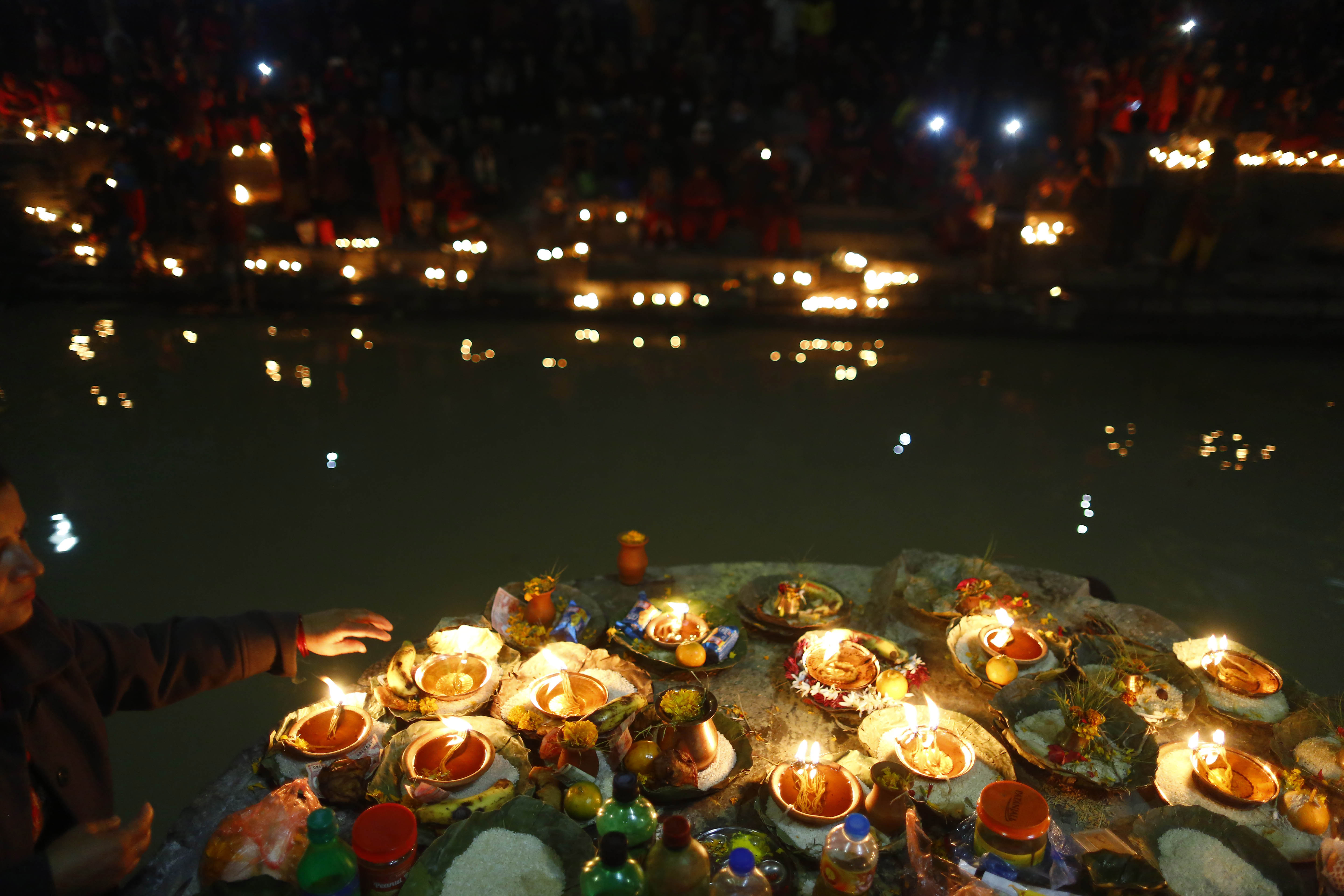 Nepali devotees light oil lamps in remembrance of their departed family members during Bala Chaturdashi festival, at Pashupatinath Temple, in Kathmandu, on Wednesday, December 05, 2018. Bala Chaturdashi festival is observed in remembrance of late beloved ones by performing rituals that are believed would secure a better place in heaven for the departed souls. Photo: Skanda Gautam/THT