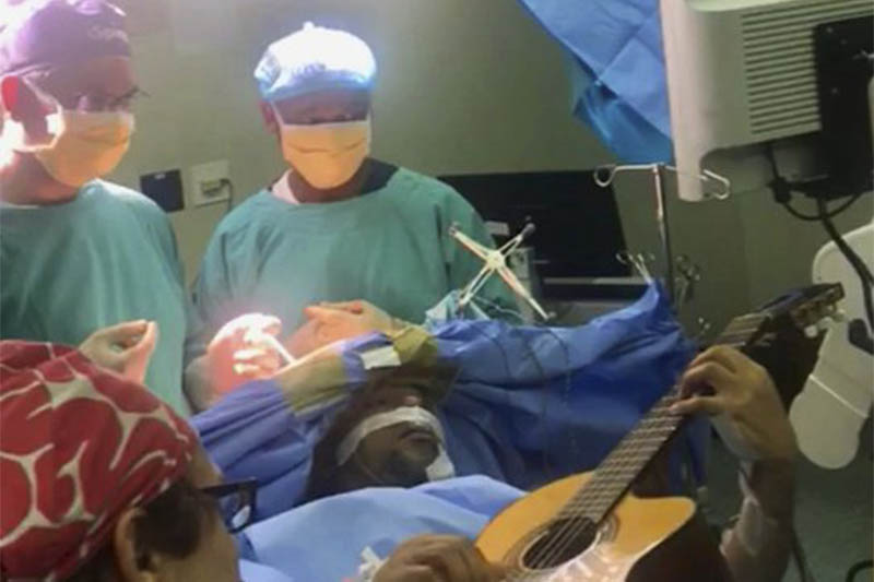 In this photo supplied by the Department of Neurosurgery, Inkosi Albert Luthuli Central Hospital on Saturday, Dec. 22, 2018, taken earlier this month during surgery South African musician, Musa Manzini, plays a guitar during brain surgery. Photo: AP