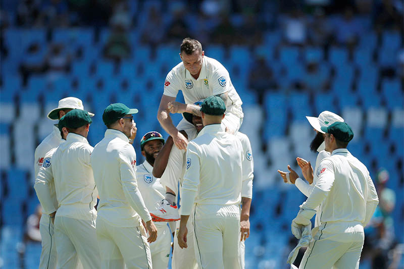 South Africa's Dale Steyn is congratulated by team mates after bowling out Fakhar Zaman. Photo: Reuters