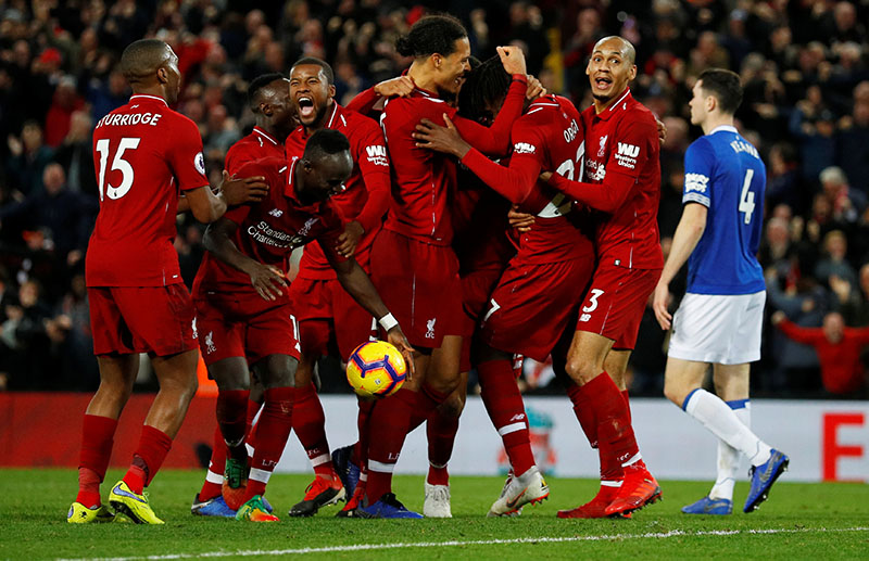 Liverpool's Divock Origi celebrates scoring their first goal with Virgil van Dijk and team mates during the Premier League match between Liverpool and Everton, at Anfield, in Liverpool, Britain, on December 2, 2018. Photo: Reuters