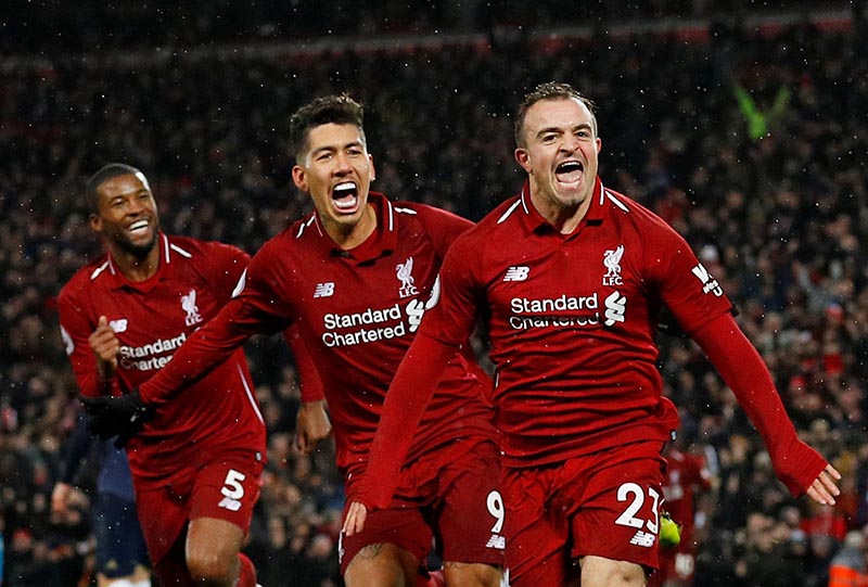 Liverpool's Xherdan Shaqiri celebrates scoring their third goal with Roberto Firmino and Georginio Wijnaldum during the Premier League match between Liverpool and Manchester United, at Anfield, in Liverpool, Britain, on December 16, 2018. Photo: Reuters
