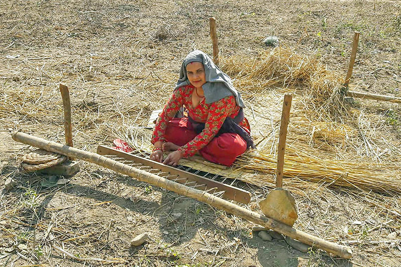 A woman weaves a traditional-style matress at Bhimad Municipality-6 in Tanahun district, on Monday, December 31, 2018. Photo: RSS