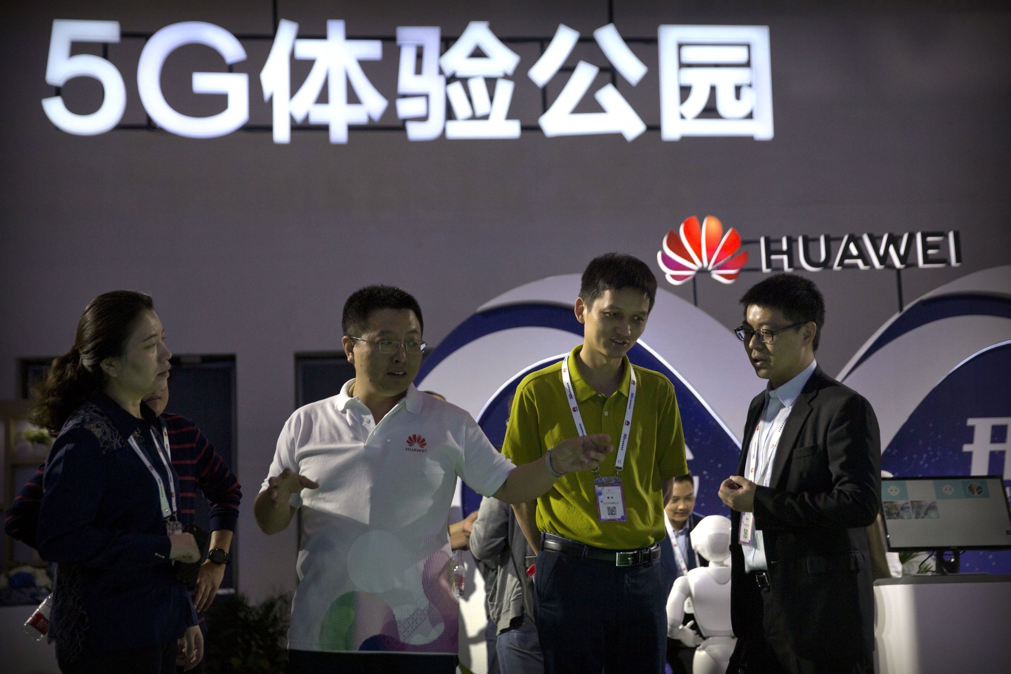 FILE - In this Sept. 26, 2018, file photo, visitors look at a display for 5G wireless technology from Chinese technology firm Huawei at the PT Expo in Beijing. Photo: AP