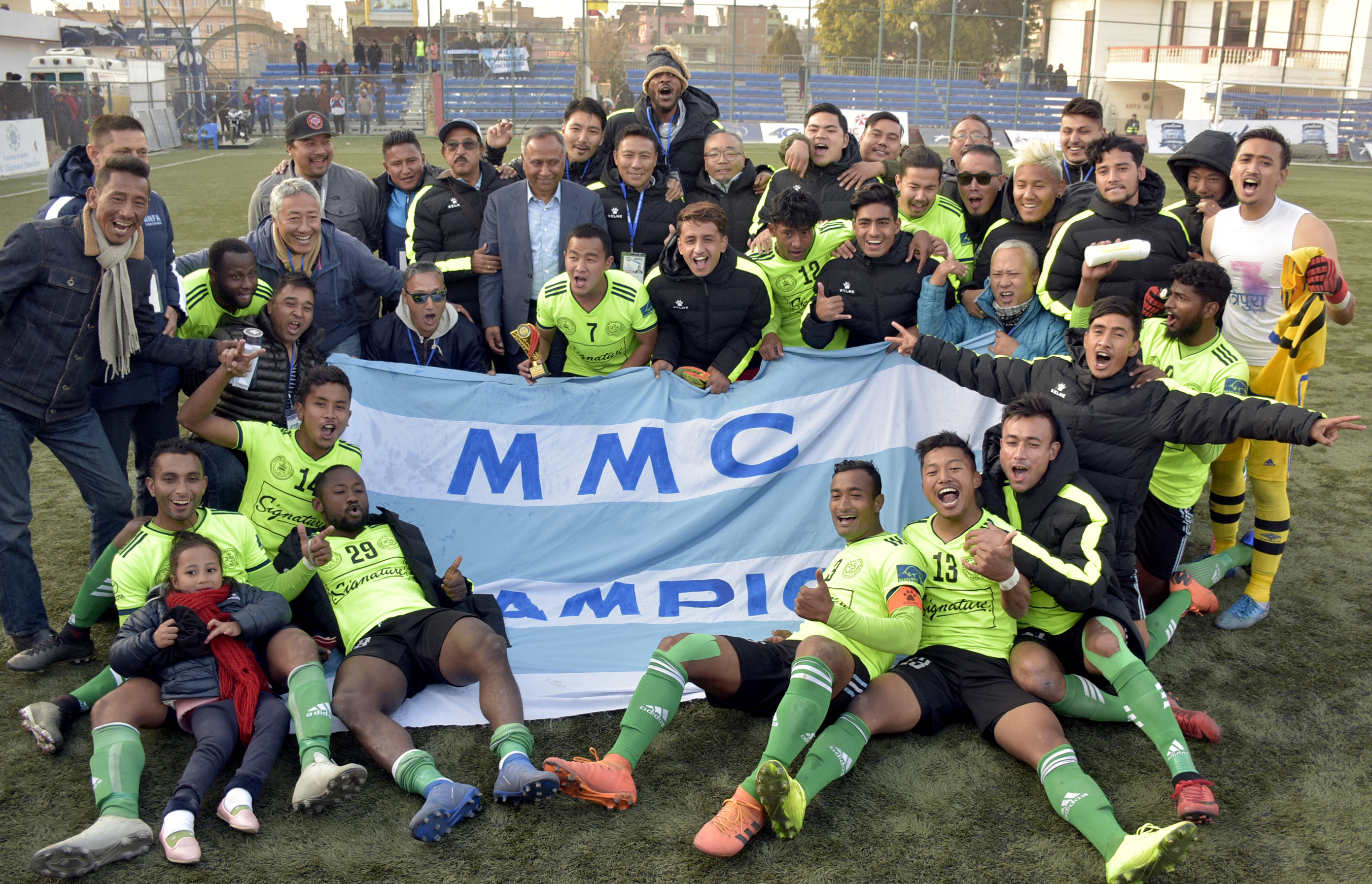 Players and officials of Signature Manang Marshyangdi Club celebrate their victory over CMG Club Sankata in the Pulsar Martyrs Memorial A Division League at the ANFA Complex grounds in Lalitpur on Thursday, December 27, 2018. Photo: THT