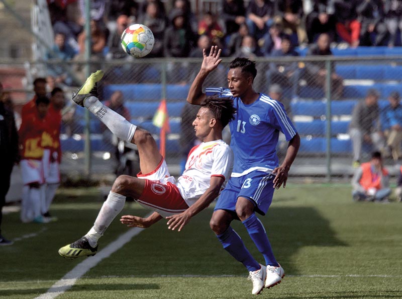 Yubraju00a0 Khadka of APF tries an overhead kick under pressure from SYCu2019s Sabin Khadka during their Pulsar Martyrs Memorial A Division League match in Lalitpur on Sunday. Photo: Naresh Shrestha/ THT