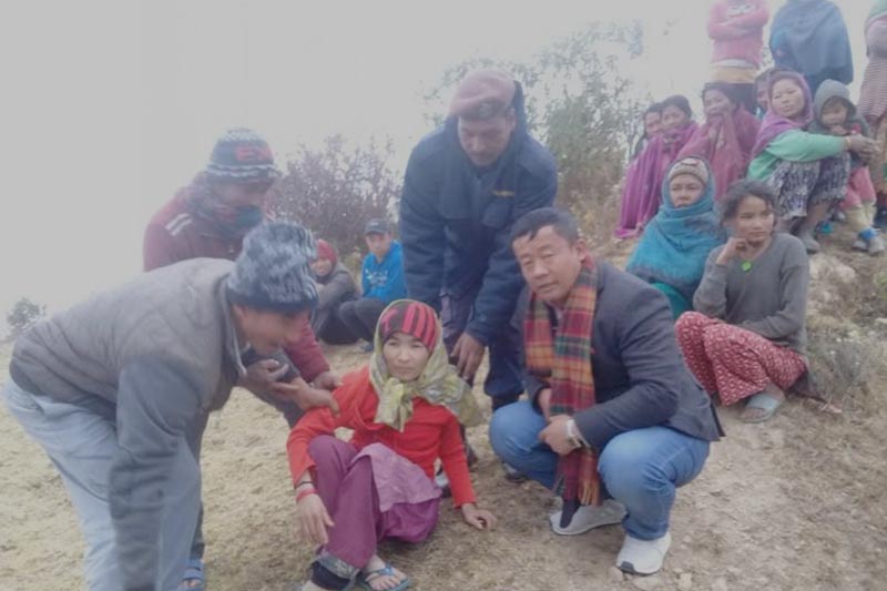 Locals preparing to take mentally ill Ramila Tamang, 33, of Chhitapokhari Basthali in Diprung Chuichumma to Kathmandu for treatment, in Khotang, on Tuesday, December 18, 2018. Photo: THT