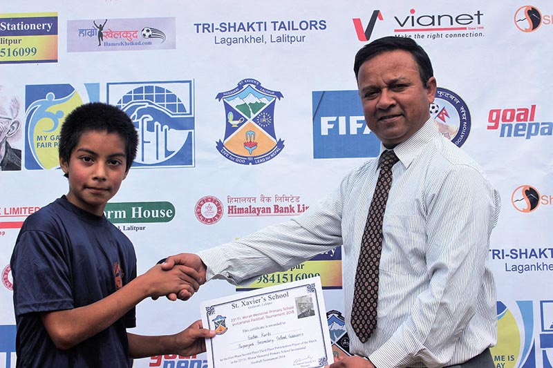 Samuel Pariyar of St Xavieru2019s School receiving the player-of-the-match award after the 23rd Father Moran Memorial Football Tournament in Lalitpur on Thursday.