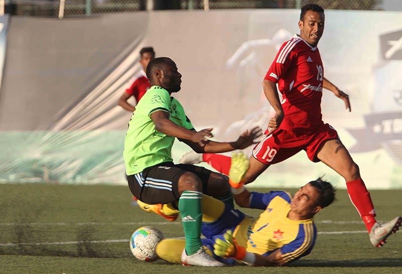 Tribhuvan Army Club goalkeeper Bikesh Kuthu slides to stop Signature Manang Marshyangdi Clubu2019s Afeez Olawale (left) during their Pulsar Martyrs Memorial A Division League match at the ANFA Complex grounds in Lalitpur on Friday, December 14, 2018. MMC won 1-0. Photo: Udipt Singh Chhetry/THT