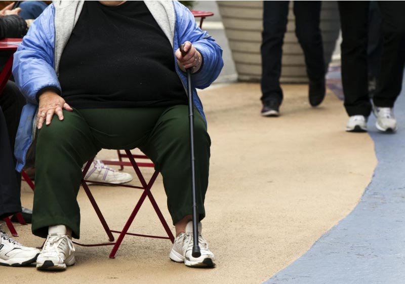FILE - An overweight woman sits on a chair in Times Square in New York, May 8, 2012. Photo: Reuters