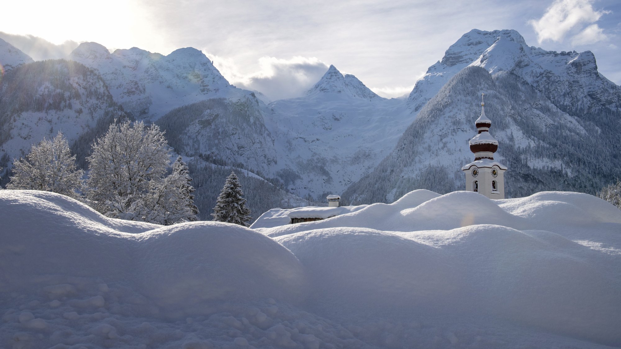 The steeple of the Loferer church is seen through the snow in Lofer, Austrian province of Salzburg on Friday, Jan. 11, 2019 after a heavy snowfall. Photo: AP