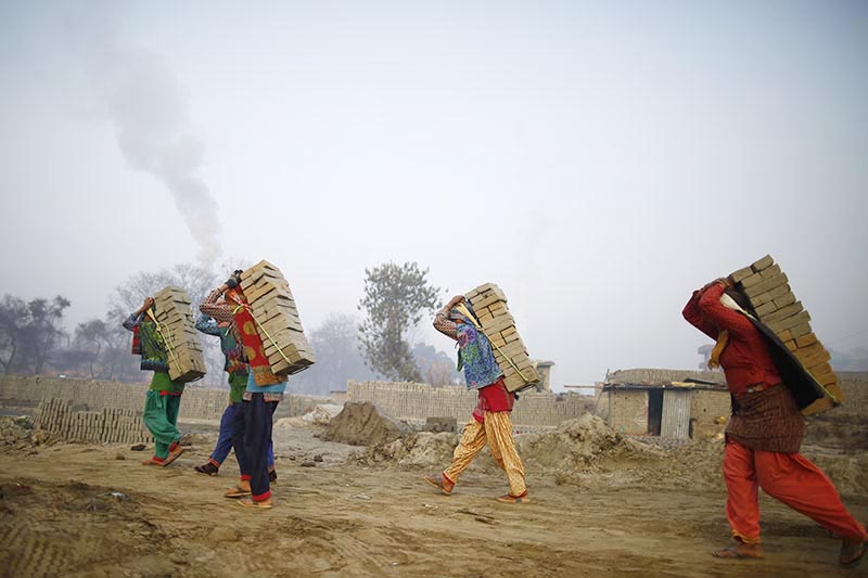 Women carry raw bricks at a brick kiln in Bhaktapur, on Thursday, January 10, 2019. Photo: Skanda Gautam/THT