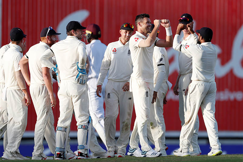 England's James Anderson celebrates with team mates after taking the wicket of West Indies' Jason Holder. Photo: Reuters