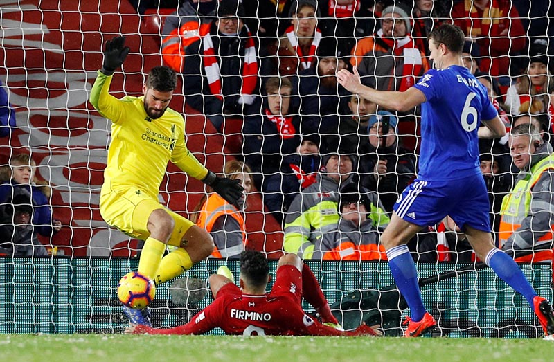 Liverpool's Alisson and Roberto Firmino in action with Leicester City's Jonny Evans during the Premier League match between Liverpool and Leicester City, at Anfield, in Liverpool, Britain, on January 30, 2019. Photo: Reuters