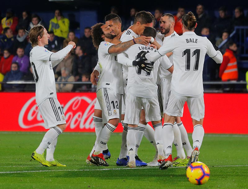 Real Madrid's Raphael Varane celebrates scoring their second goal with Marcelo and team mates during the La Liga match between Villarreal and Real Madrid, at Estadio de la Ceramica, in Villarreal, Spain, on January 3, 2019. Photo: Reuters
