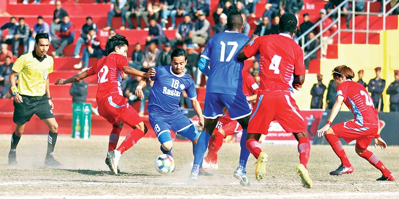 Rupesh KC of Ruslan Three Star Club (centre) tries to beat past a player from Valley Chyasal Youth Club during their quarter-final match of the third Nepal Ice International Farwest Khaptad Gold Cup at the Dhangadhi Stadium on Monday. Photo: THT