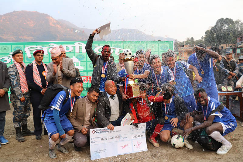 Triveni Youth Club players and officials celebrate after lifting the 27th Triveni Cup title in Besisahar of Lamjung district, on Friday, January 04, 2018. Photo: Ramji Rana