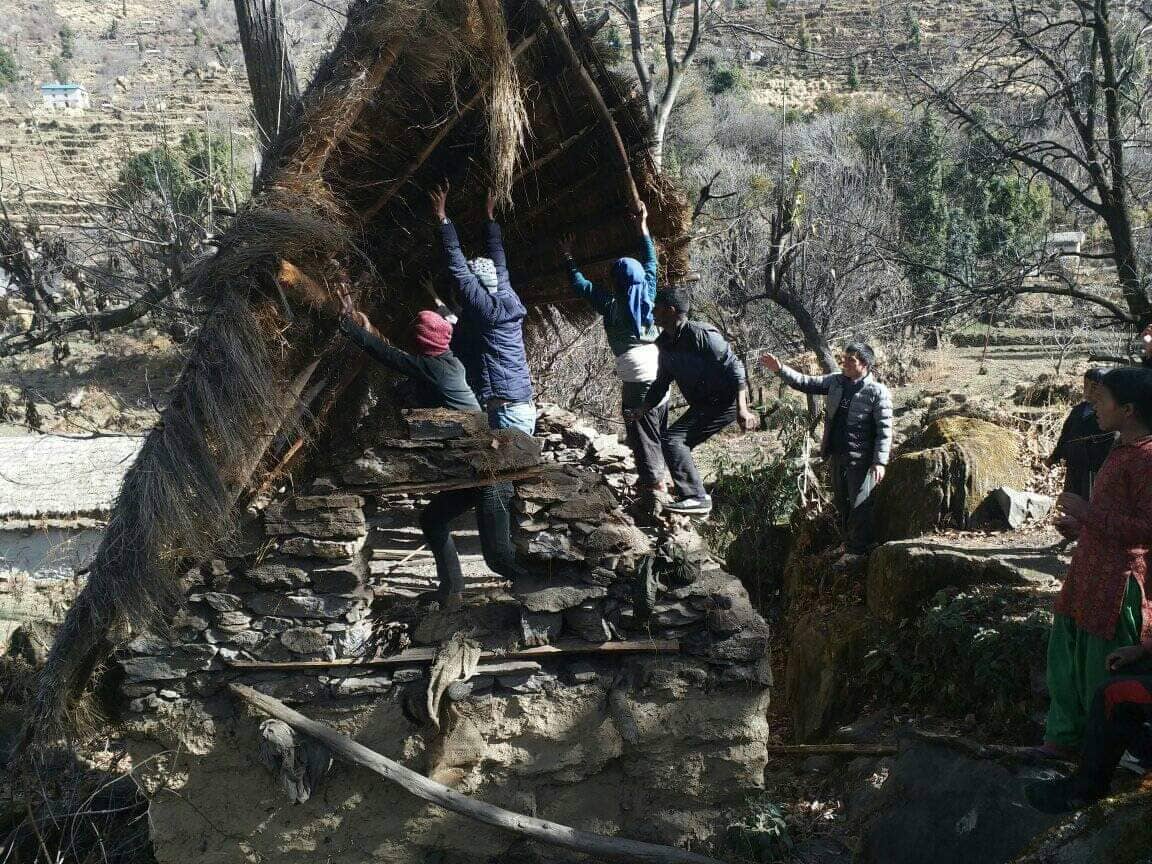 Residents of Nuri in Budinanda Municipality in Bajura pull down a menstrual hut on Thursday, January 17, 2019. Photo: Prakash Singh/THTn