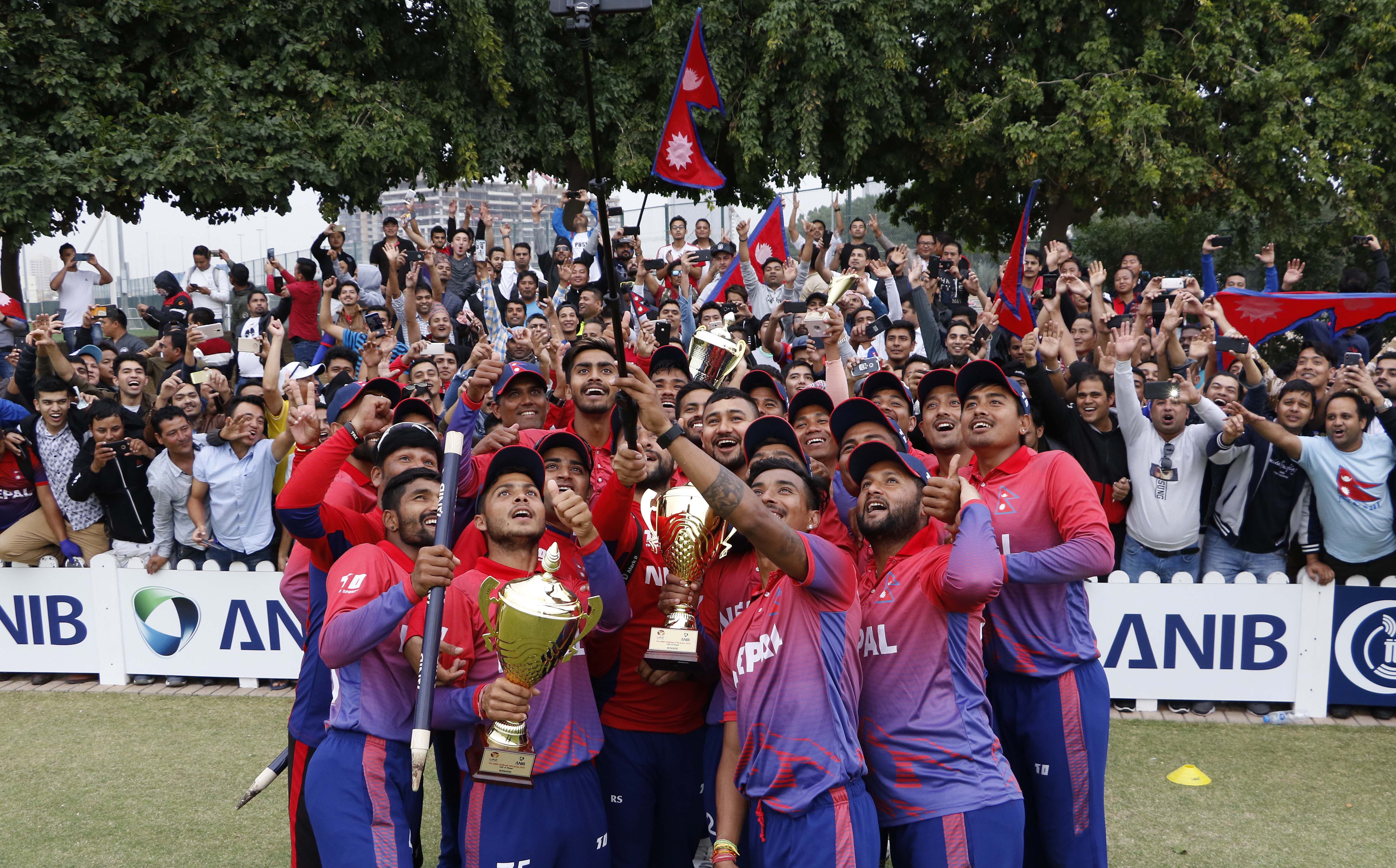 Nepali National Cricket Team pose with trophies and supporters after winning maiden ODI and T20I series against UAE at ICC Academy, Dubai on February 3, 2018. Photo: cricketingnepal.com