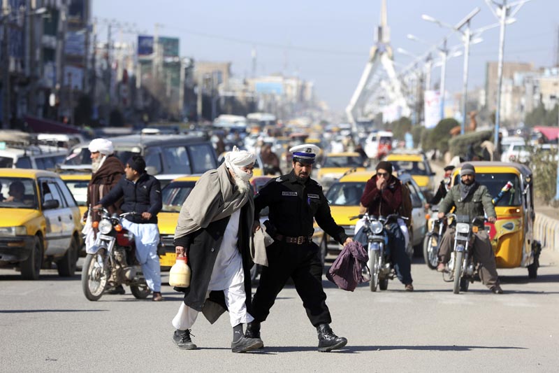 A traffic police officer escorts an elderly man across a busy intersection in the city of Herat province, Afghanistan, Thursday, February 21, 2019.Photo: AP