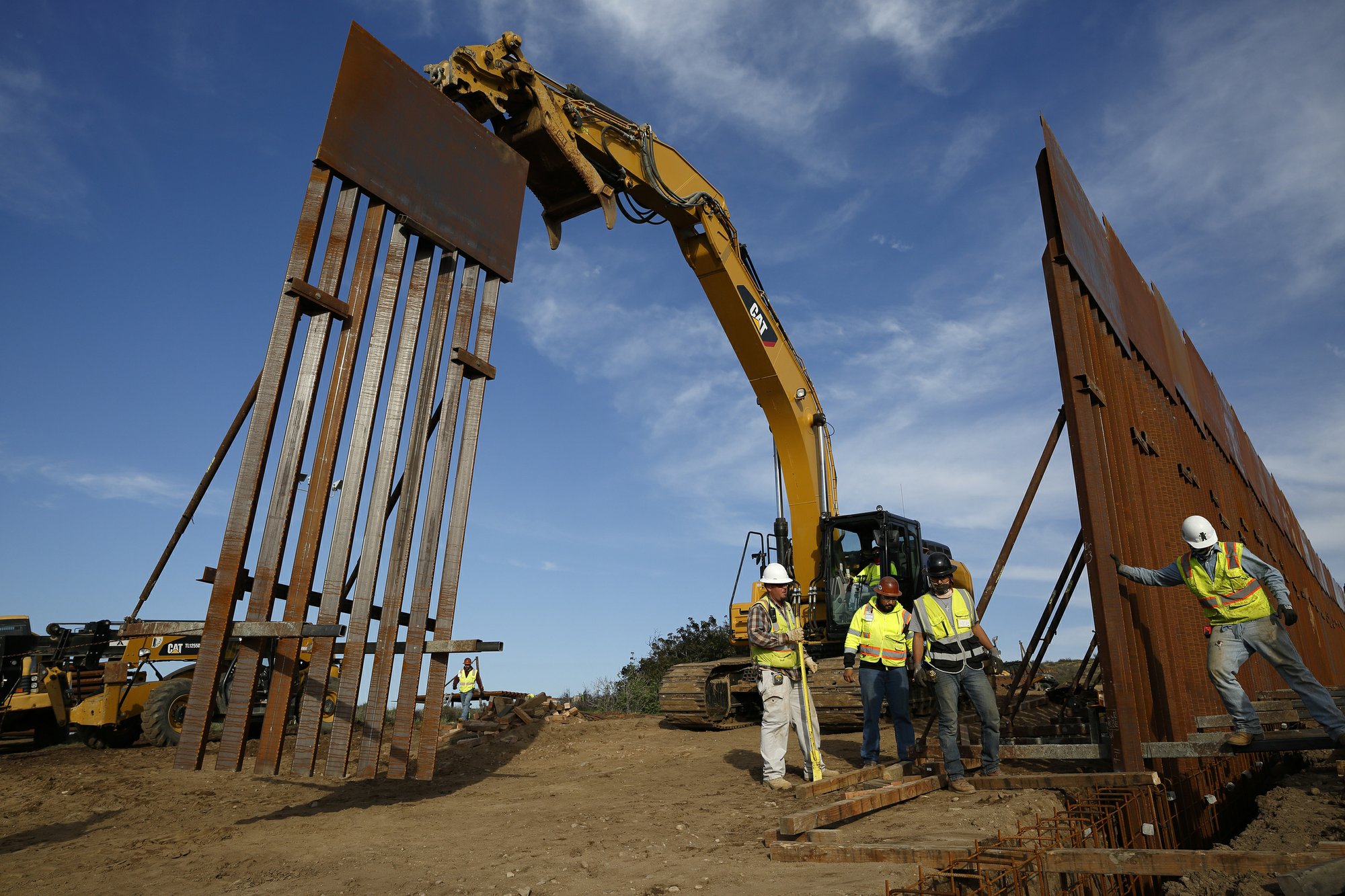 FILE - In this Jan. 9, 2019 file photo, construction crews install new border wall sections seen from Tijuana, Mexico. Photo: AP