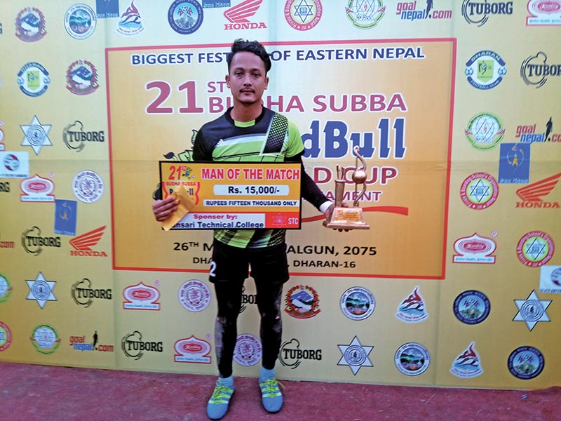 Dharan FC goalkeeper Binay Shrestha holds the man-of-the-match award after beating CMG Club Sankata in the 21st Budha Subba Red Bull Gold Cup match in Sunsari on Thursday. Photo: THT