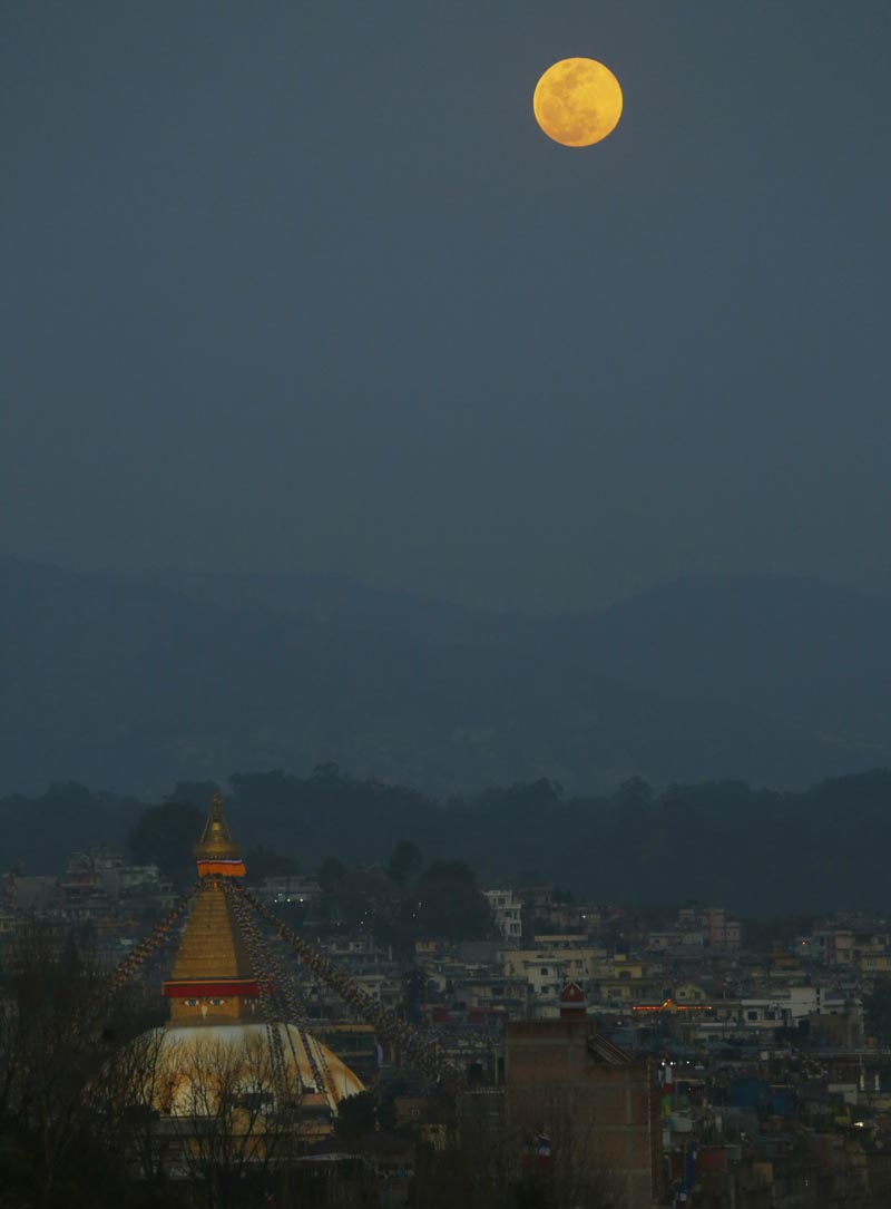 A full moon is seen rising behind the Boudhanath Stupa in Kathmandu, Nepal, Tuesday, February 19, 2019. Photo: Niranjan Shrestha/AP
