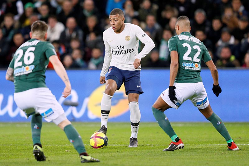 Paris St Germain's Kylian Mbappe in action with Saint-Etienne's Mathieu Debuchy and Kevin Monnet-Paquet during the Ligue 1 match between AS Saint-Etienne and Paris St Germain, at Stade Geoffroy-Guichard, in Saint-Etienne, France, on February 17, 2019. Photo: Reuters