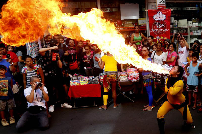 A fire-eater performs during celebrations of the Lunar New Year in the Chinatown district of Manila, Philippines, on Tuesday, February 05, 2019. Photo: AP