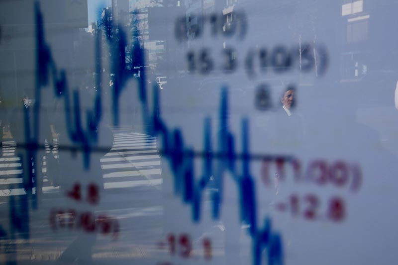 FILE: A man is reflected on an electronic board showing a graph analyzing recent change of Nikkei stock index outside a brokerage in Tokyo, Japan, January 7, 2019.Photo: Reuters/file