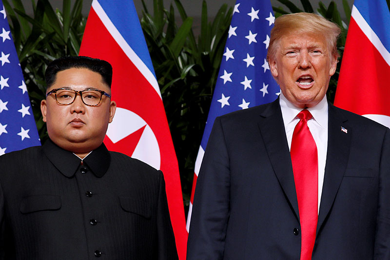 File - US President Donald Trump and North Korean leader Kim Jong Un react at the Capella Hotel on Sentosa island in Singapore, June 12, 2018. Photo: Reuters