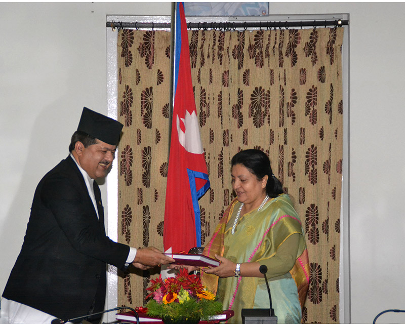 Attorney General Agni Prasad Kharel submitting the annual report of the Office of the Attorney General and its subordinate bodies to President Bidya Devi Bhandari, at the Office of the President, Sheetal Niwas, Kathmandu, on Monday, February 18, 2019. Photo: RSS