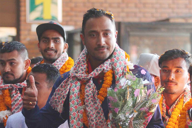 (From left) Skipper Paras Khadka, Sompal Kami and Bhim Sarki waving to the crowd upon their arrival at TIA, in Kathmandu, on Monday, February 4, 2019. Photo: Udipt Singh Chhetry/THT