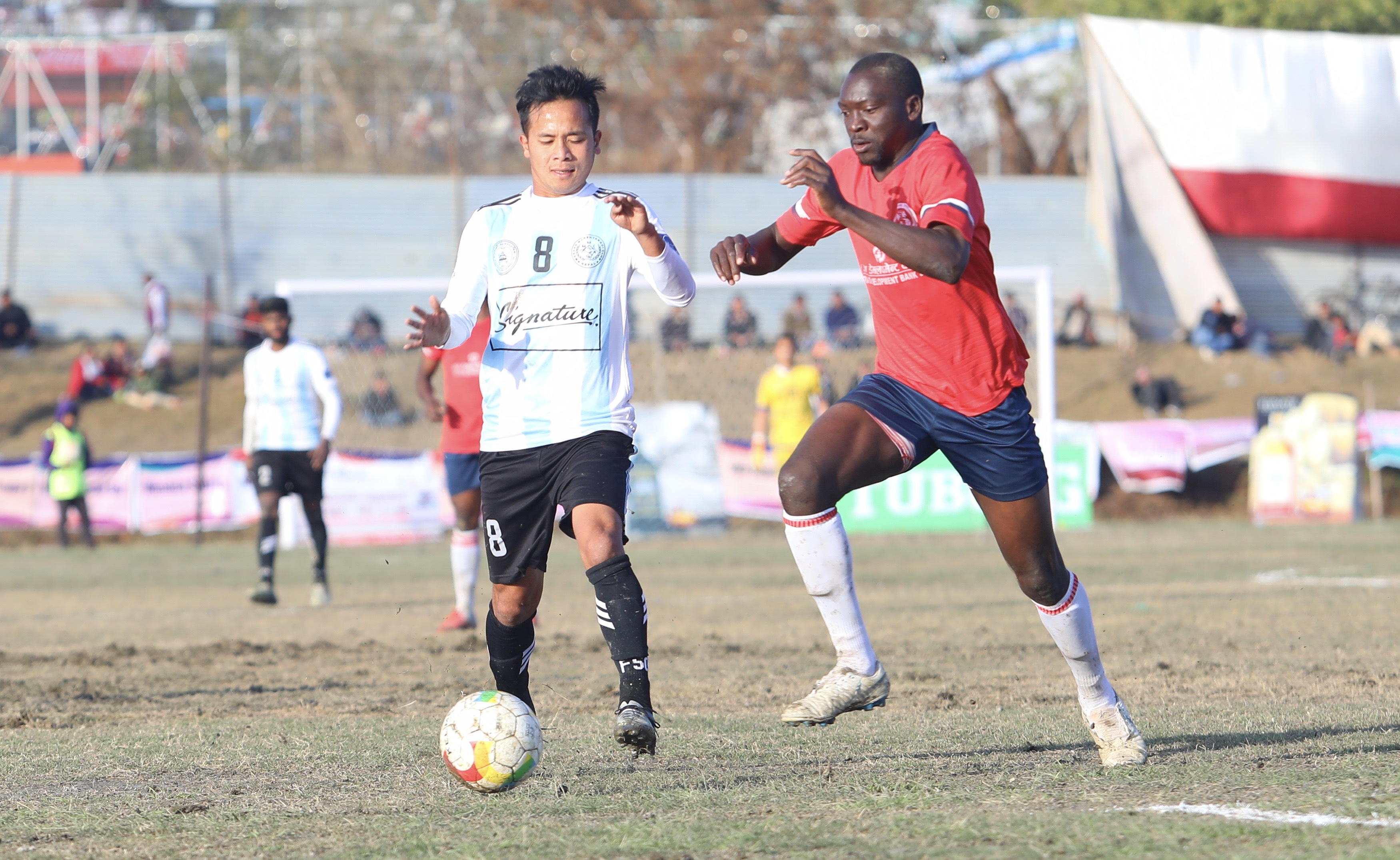 Players of Signature Manang Marshyangdi Club (left) and Dauphins Family Club vie for the ball during their Pokhara Cup semi-final match in Pokhara on Saturday, February 9, 2019. Photo: AP