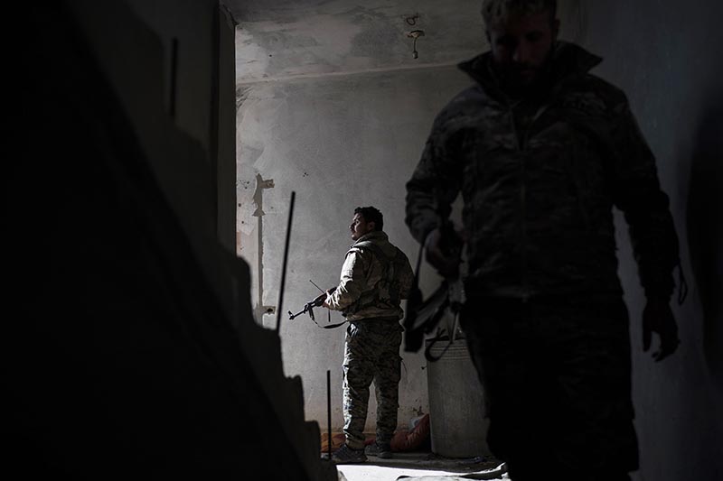 US-backed Syrian Democratic Forces (SDF) fighters walk in a building as fight against Islamic State militants continue in the village of Baghouz, Syria, Saturday, February 16, 2019. Photo: AP
