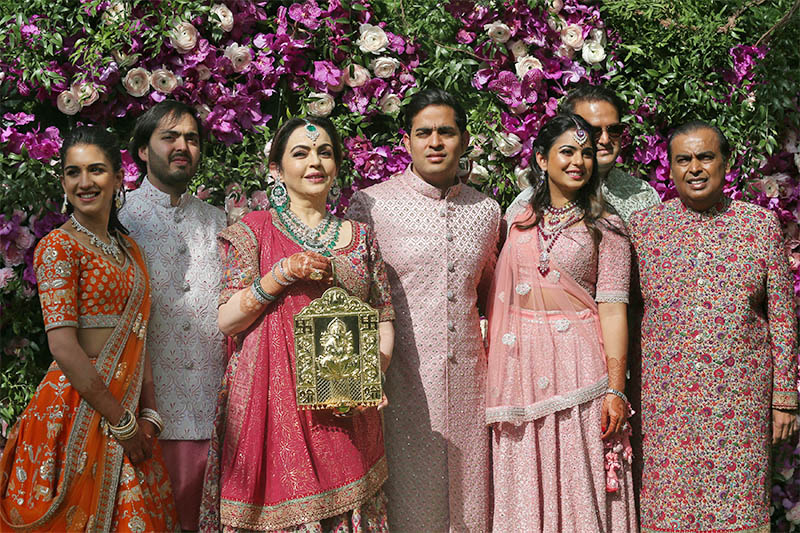 (L-R) Radhika Merchant, Anant Ambani, Nita Ambani, Akash Ambani, Isha Piramal, Anand Piramal and Mukesh Ambani, the Chairman of Reliance Industries, pose during a photo opportunity at the wedding ceremony of Akash, at Bandra-Kurla Complex in Mumbai, India, March 9, 2019. Photo: Reuters