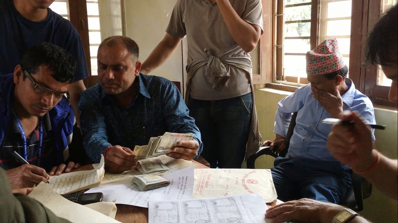 CIAA Officials cross check pins of bribe money recovered from forest division staffers. Photo: Pushpa Raj Khatiwada/ THT
