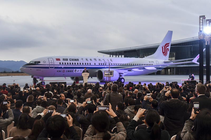 On this photo released by Xinhua News Agency, invited guests take photos of the Boeing 737 Max 8 airplane deliver to Air China during a ceremony at Boeing Zhoushan 737 Completion and Delivery Center in Zhoushan, east China's Zhejiang Province on  December 15, 2018. Photo: Xu Yu/Xinhua via AP.