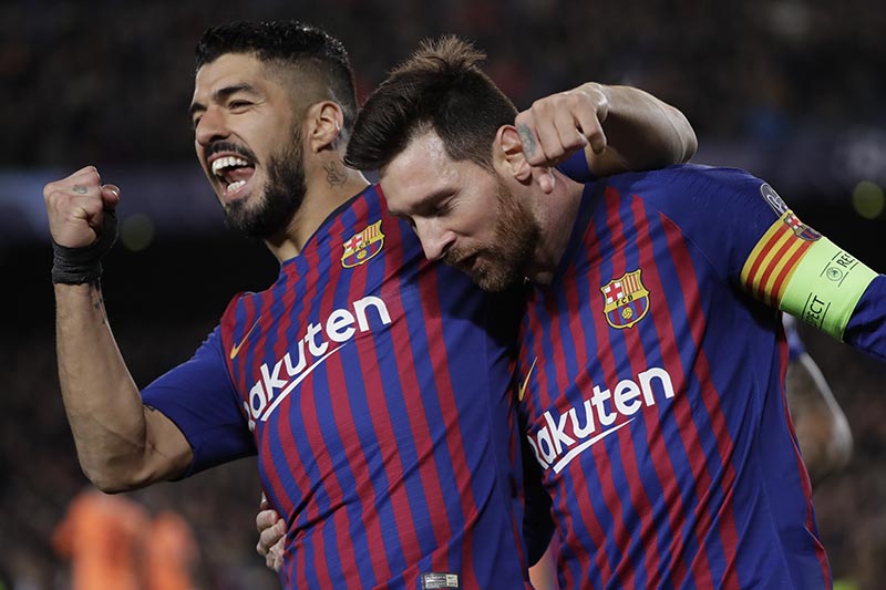 Barcelona's Lionel Messi (right) and Barcelona's Luis Suarez celebrate after Messi scored his side's third goal during the Champions League round of 16, 2nd leg, soccer match between FC Barcelona and Olympique Lyon at the Camp Nou stadium in Barcelona, Spain, Wednesday, March 13, 2019. Photo: AP