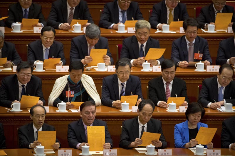 Delegates look at their ballots during a plenary session of China's National People's Congress (NPC) at the Great Hall of the People in Beijing on March 19, 2018. Photo: AP/File