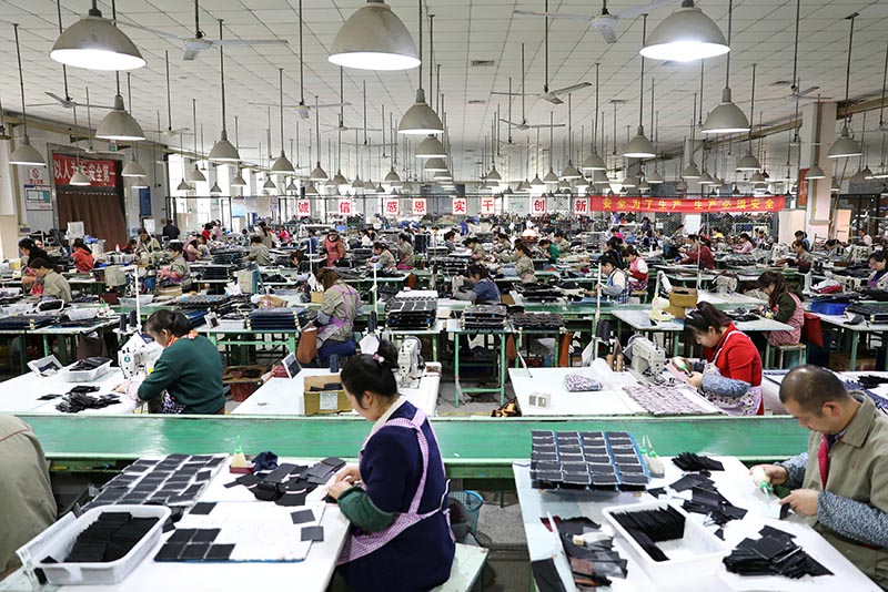 Employees work on the production line of a factory manufacturing fashion accessories in Sihong county, Jiangsu province, China March 27, 2019. Photo: Reuters